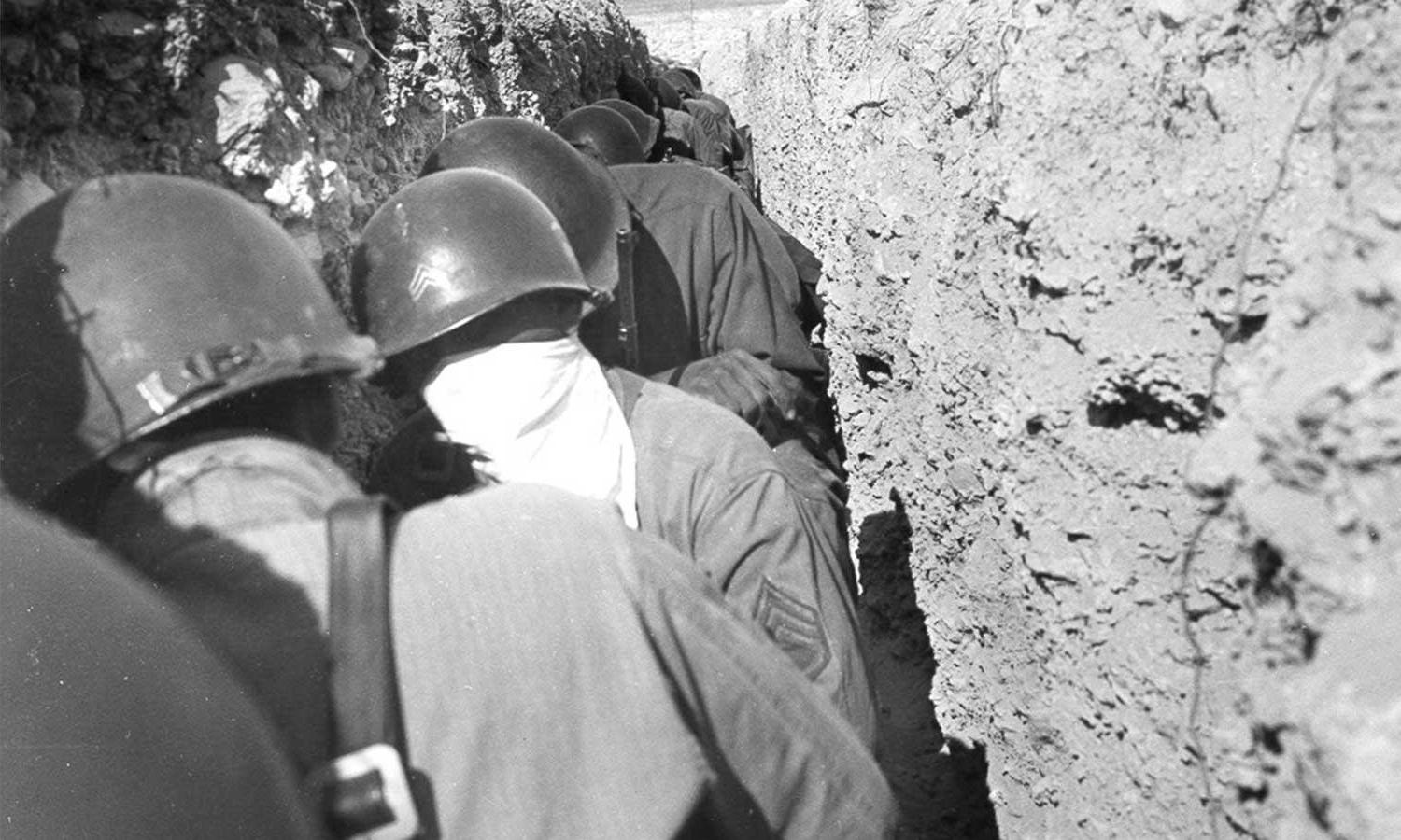Atomic troops crouching in trench 